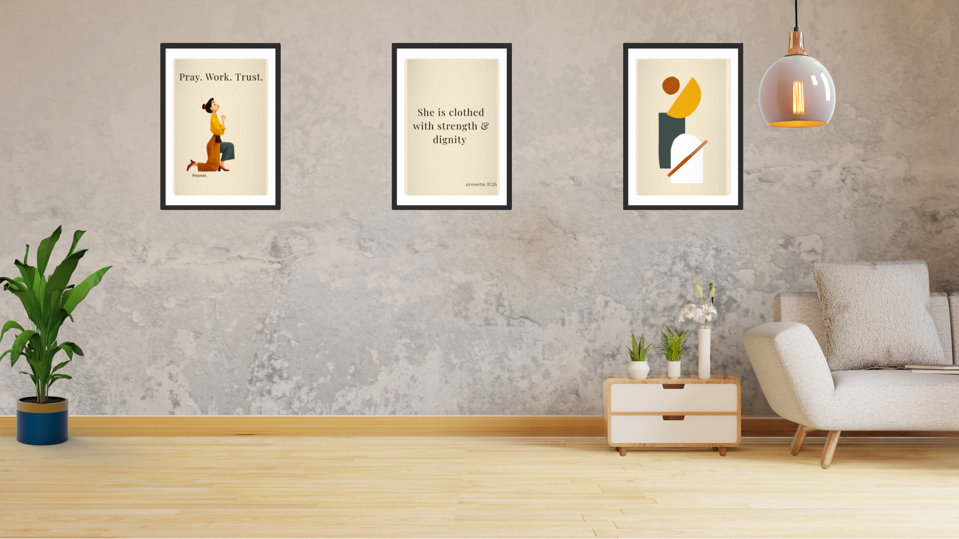 Living room with framed artwork on a gray wall, a plant, and a sofa.